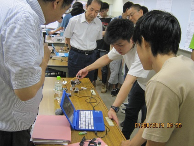 [ 画像 ] Presentation session of a hand-cranked Japanese spinning top (koma) and motorized camera stand.
